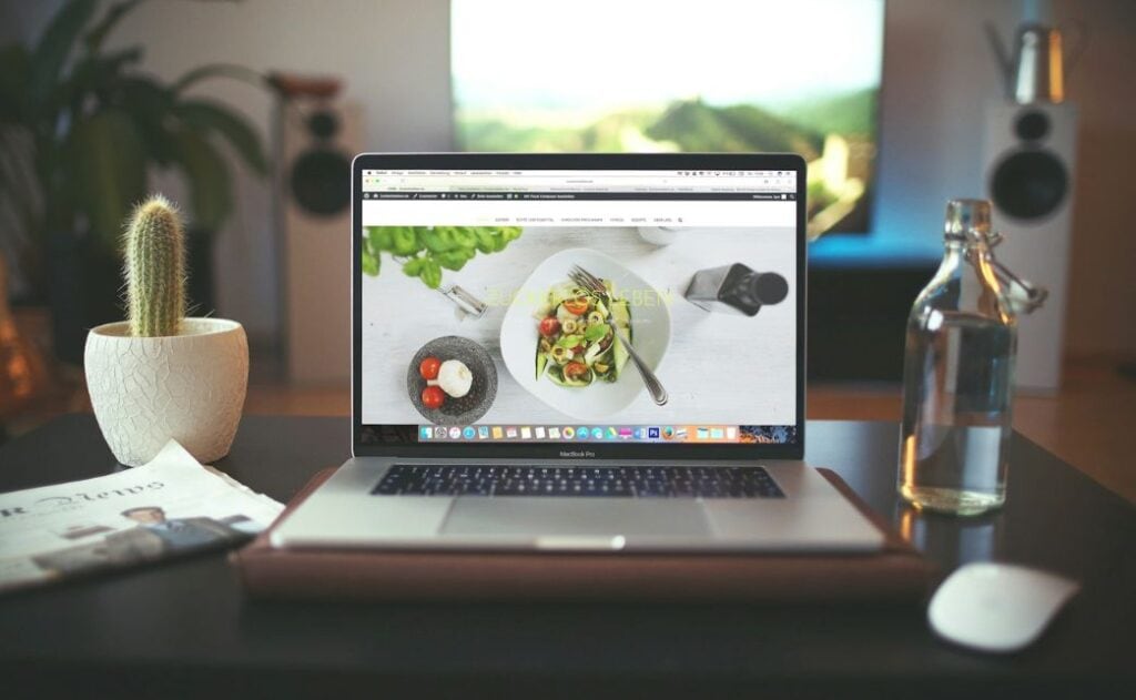 a laptop open on a desk. 